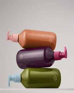 Three stacked colorful pump bottles with body wash for Target brand identity design by Marc Atlan