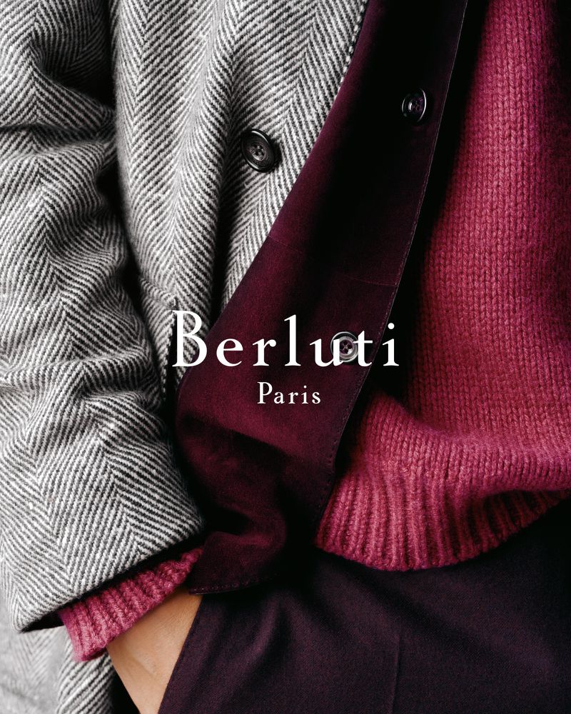 Fashion shot of a herringbone wool coat paired with a burgundy sweater and dress pants, showcasing a sophisticated and warm aesthetic.
