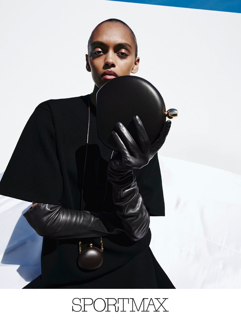 Model in black top and long leather gloves holding round black clutch for Sportmax Fall-Winter campaign