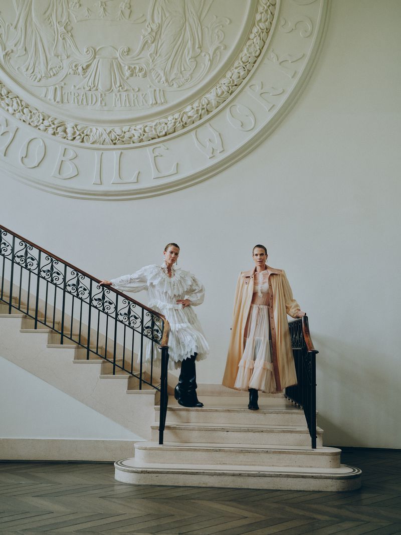 Lady Amelia Spencer and Lady Eliza Spencer posing on a grand staircase for a Vanity Fair U.S. fashion editorial.