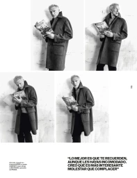 Black and white editorial layout featuring actor Vincent Cassel holding a magazine while wearing a heavy overcoat