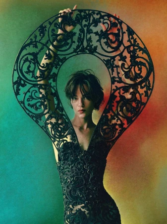 Model Lisa Louis Fratani poses inside an ornate wrought-iron frame against a colorful gradient backdrop in Anatomy of a Dream.