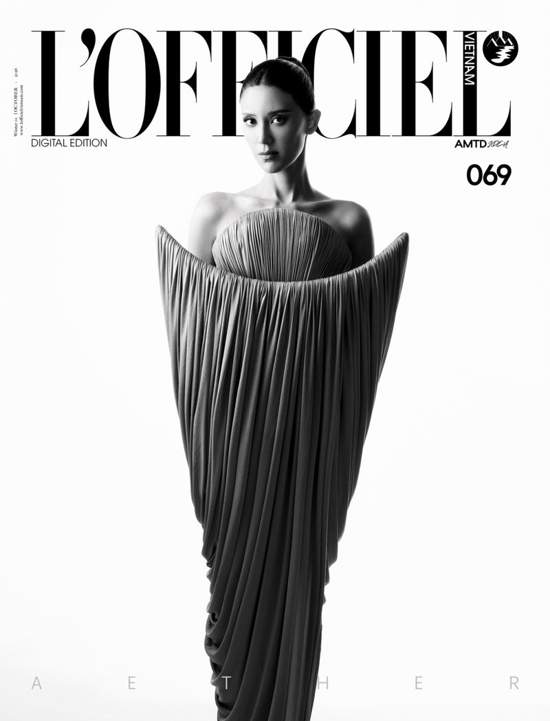 Model wearing a sculptural pleated dress against a plain white background for L'Officiel Vietnam October 2026 digital edition
