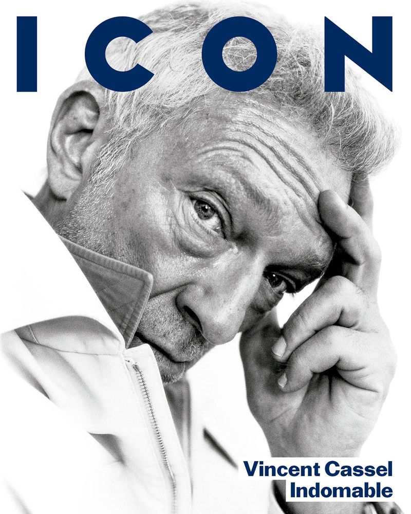 Portrait of actor Vincent Cassel with hand to forehead against a bright white background for El Pais Icon Magazine