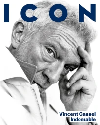 Portrait of actor Vincent Cassel with hand to forehead against a bright white background for El Pais Icon Magazine