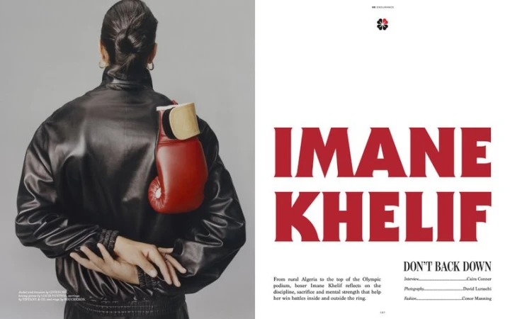 Rear view of boxer Imane Khelif wearing a black leather jacket with a red boxing glove tucked into the shoulder strap