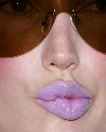 Extreme close-up portrait of model Meredith Duxbury wearing purple lipstick and tinted sunglasses, captured for Get Ready With Meredith by Kévin Drelon.