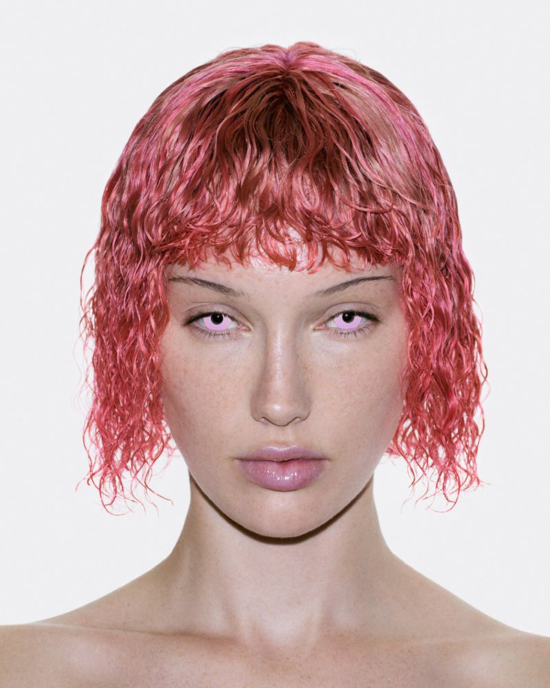 Portrait of Meredith Duxbury with wet pink bob hair and light pink eyes against a plain white background