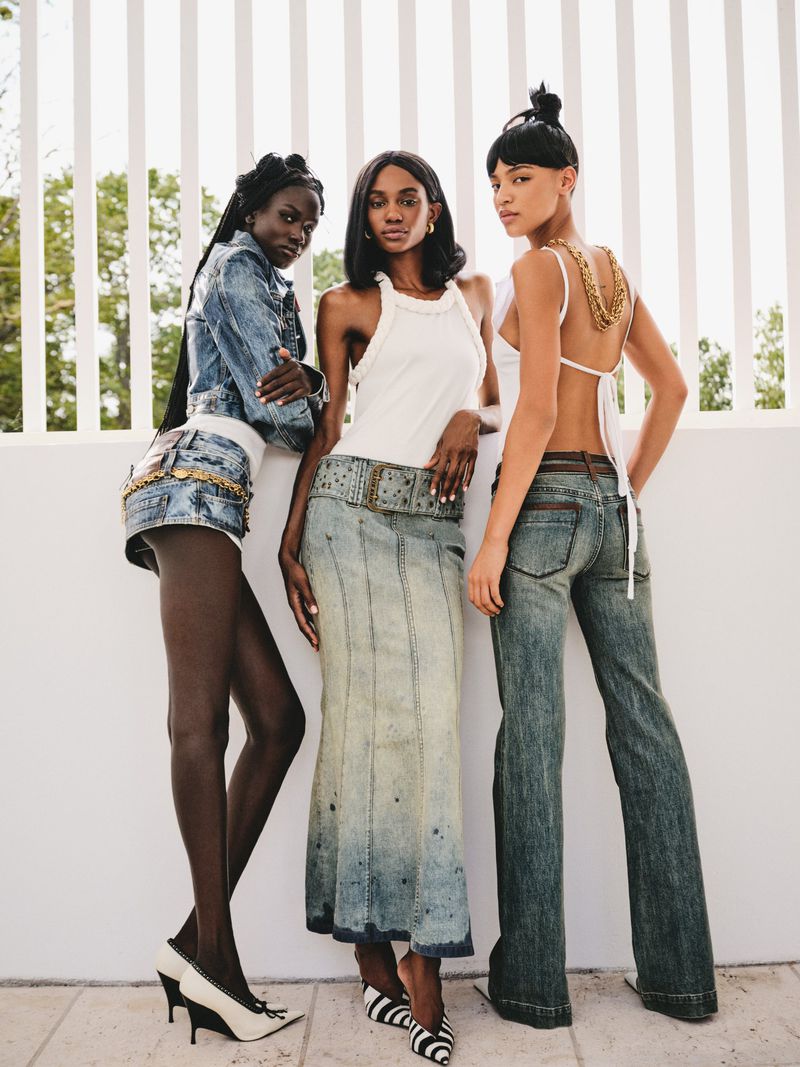 Three female models posing against a white vertical slat wall for 72 Magazine
