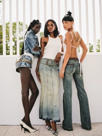 Three female models posing against a white vertical slat wall for 72 Magazine