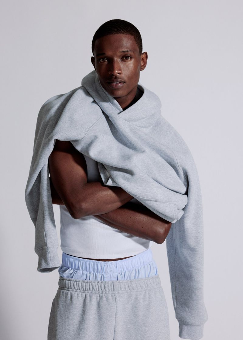 Model Malik Anderson in a grey hoodie and sweatpants for Aritzia shot by Philip-Daniel Ducasse