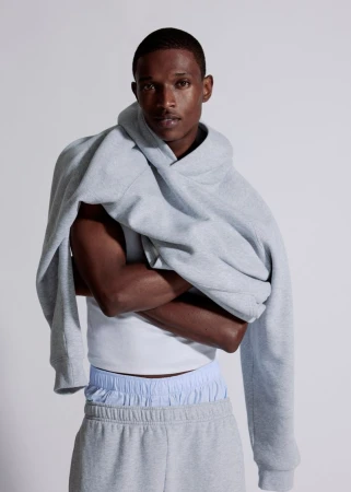 Model Malik Anderson in a grey hoodie and sweatpants for Aritzia shot by Philip-Daniel Ducasse