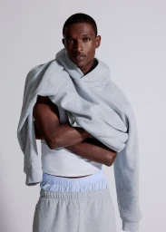 Model Malik Anderson in a grey hoodie and sweatpants for Aritzia shot by Philip-Daniel Ducasse