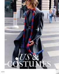 Model walking on a city street wearing a grey coat and a red and blue striped scarf for a Madame Figaro editorial.