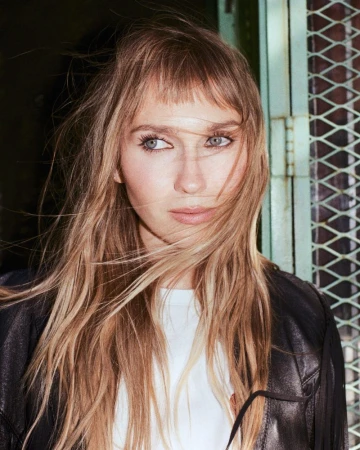 Portrait of Veronika Slowikowska with blonde hair and bangs wearing a black jacket, captured by Brendan Wixted for Nylon Magazine