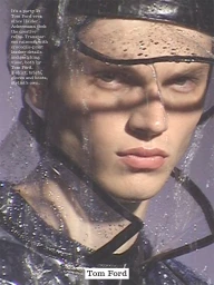 Close-up portrait of a male model wearing a dark visor and wet transparent hood for Fantastic Man AW26 collection