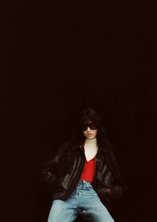 Model in black leather jacket and sunglasses against dark background for The Frankie Shop SS27 lookbook