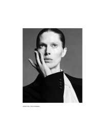 Black and white portrait of model Iselin Steiro with hand to face wearing a tailored jacket and white shirt