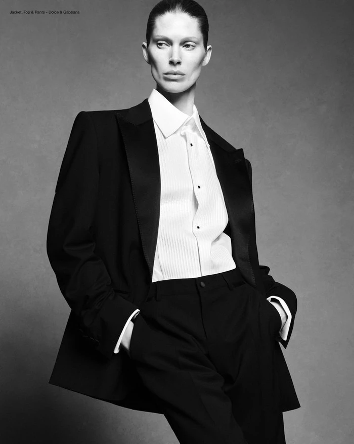 Model Iselin Steiro wearing a black blazer and white shirt against a grey studio backdrop