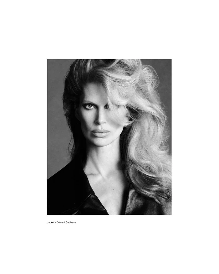 Black and white portrait of model Iselin Steiro with voluminous blonde hair wearing a dark jacket.