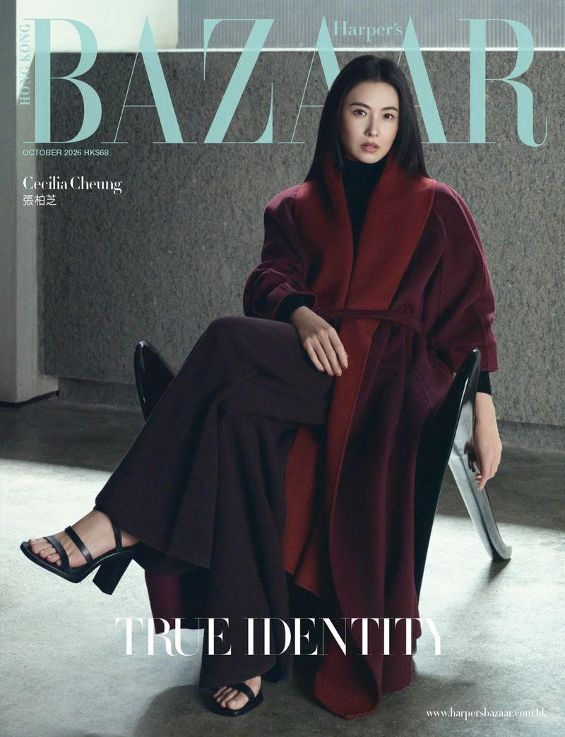 Cecilia Cheung seated in a black chair wearing a burgundy coat for Harper's Bazaar Hong Kong magazine cover editorial