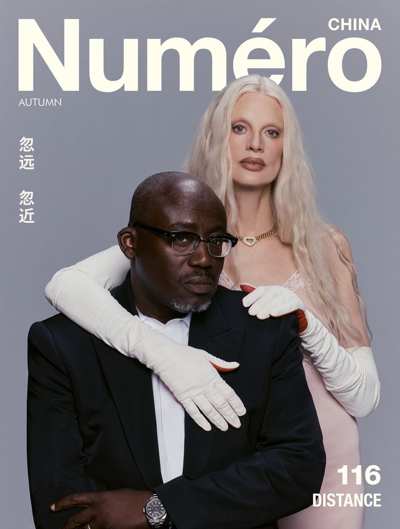 Cover of Numéro China featuring a Black man in a black suit and white shirt with a blonde woman in a pink dress and white gloves.