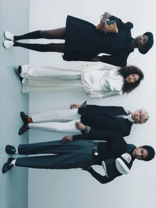Four models standing in a row against a plain light wall for a Manifesto Magazine editorial