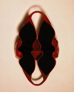 Red leather handbag viewed from above against a neutral background for Harper's Bazaar Poland