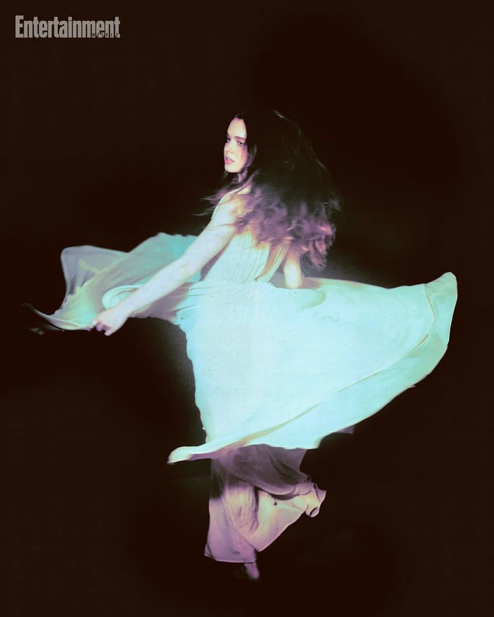 A woman in a flowing light-colored gown spinning in the dark for an Entertainment Weekly feature.