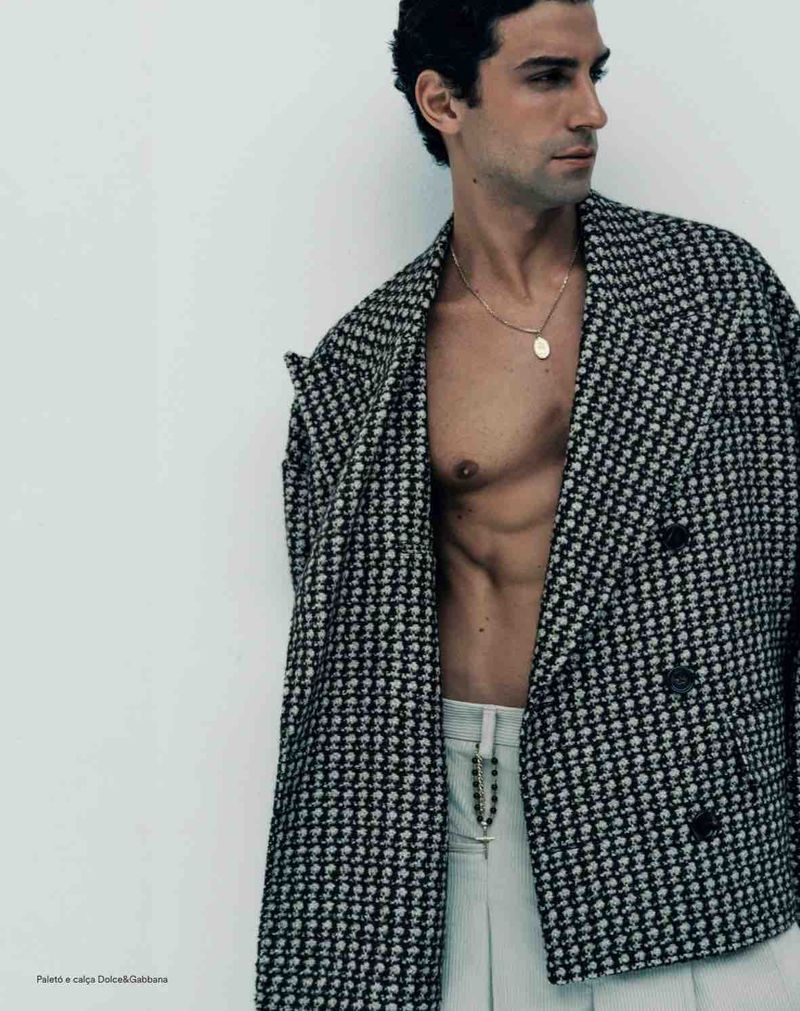 Model Francisco Faria wearing a black and white houndstooth double-breasted jacket with light trousers, photographed by Guilherme da Silva