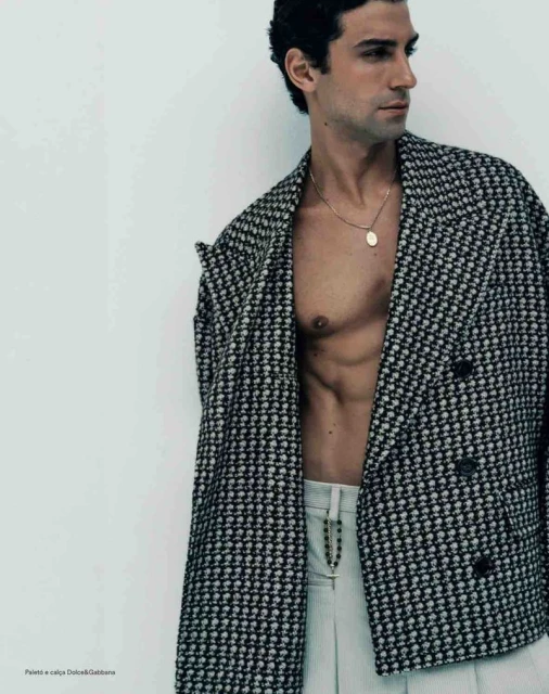 Model Francisco Faria wearing a black and white houndstooth double-breasted jacket with light trousers, photographed by Guilherme da Silva