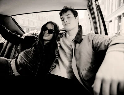 Black and white portrait of a man and woman sitting together inside the back seat of a car for J. Crew outerwear collection.