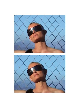 Model Amber Valletta wearing oversized sunglasses against a chain-link fence in a System Magazine fashion editorial