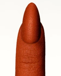 Macro shot of a finger with a textured, rust-orange coated nail against a clean white background