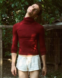 Slava Sikorski wearing a fitted red turtleneck and white shorts outdoors for Vanity Teen Magazine