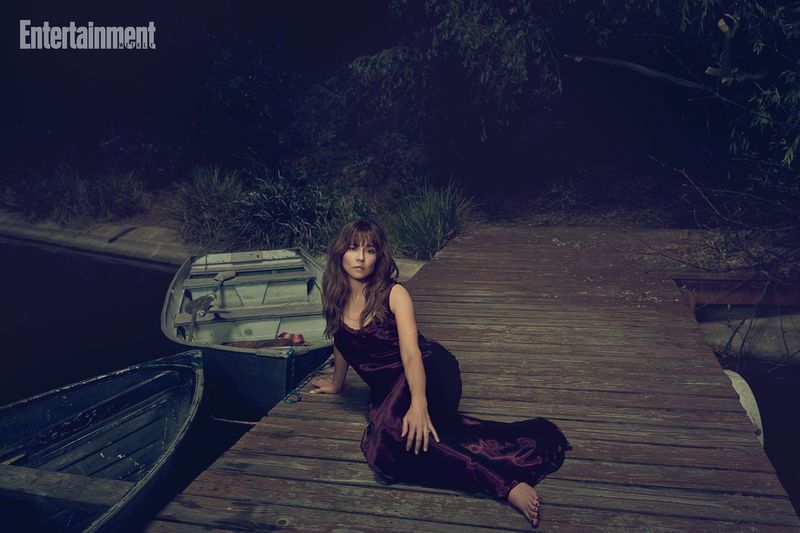 Linda Cardellini sitting on a wooden dock beside two small boats at night for Entertainment Weekly photographed by Brian Bowen Smith.
