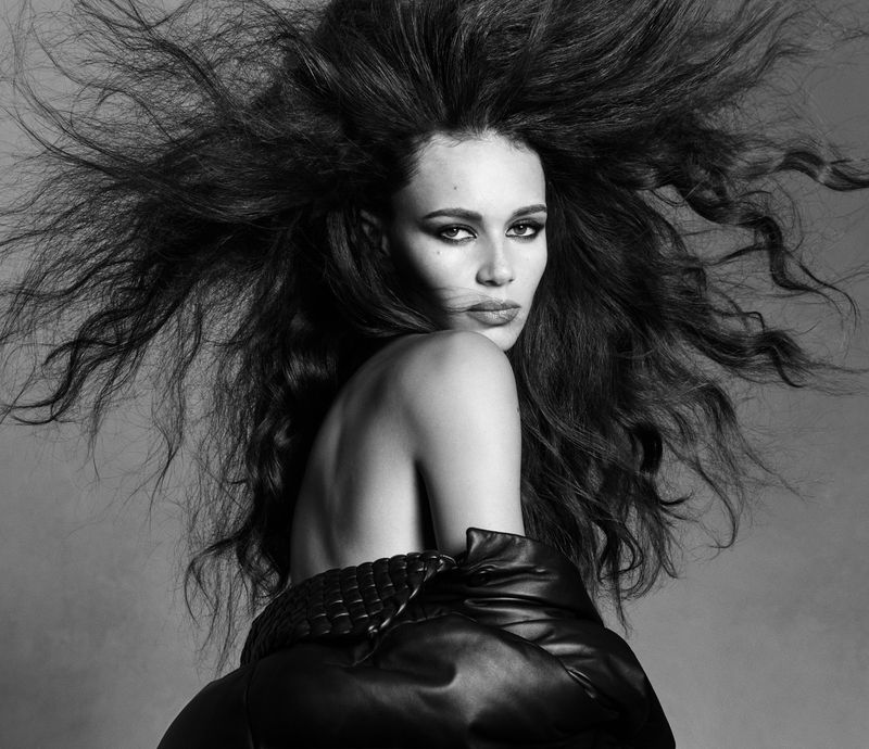 Model Binx Walton with voluminous dark hair and leather jacket in a black and white portrait by Luigi and Iango for Double Vision.