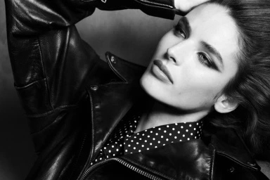 Close-up portrait of model Libby Taverner wearing a black leather jacket and polka dot shirt by Double Vision.