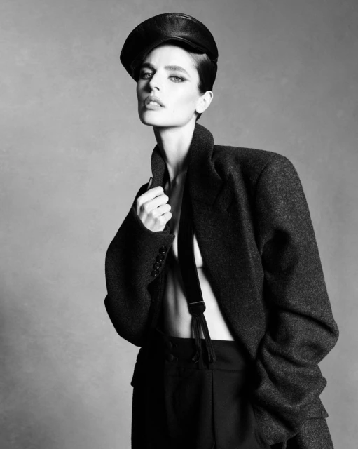 Model Libby Taverner wearing a dark leather cap and oversized coat for Double Vision, photographed by Luigi & Iango
