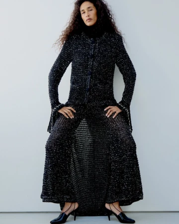 Model Shani Feldman in a textured black tweed coat against a seamless white background for M Le magazine du Monde