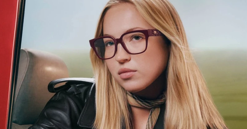 Model Lila Moss wearing burgundy eyeglasses and a black leather jacket for the Burberry Eyewear Fall-Winter 2026 Campaign
