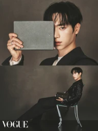 Actor Kang Jun holding a grey folder in front of his face and seated on a chair in a Vogue Hong Kong fashion editorial image.