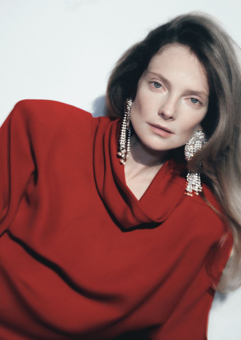 Model Eniko Mihalik wearing a red draped top and crystal tassel earrings for Forbes Spain shot by Javier Biosca