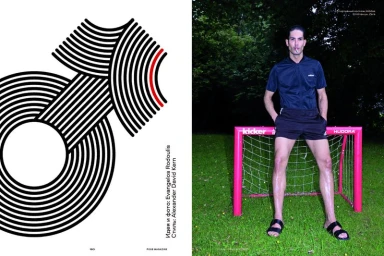 Man in dark athletic shirt and shorts posing behind a small pink soccer goal on grass