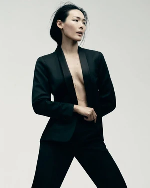 Model wearing a black pantsuit against a plain white background for Grazia UK