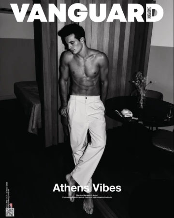 Monochrome magazine cover portrait of a shirtless man wearing light trousers standing indoors