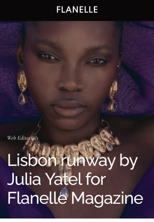 Close-up portrait of a Black woman wearing sculptural gold face earrings, a gold face necklace, and purple apparel.
