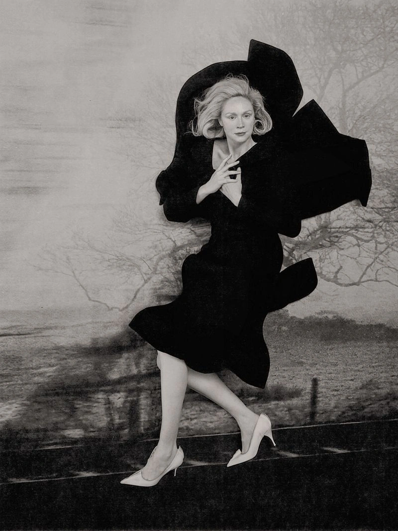 Gwendoline Christie wearing a black sculptural dress against a textured illustrated backdrop in the Bauhaus Ballet project