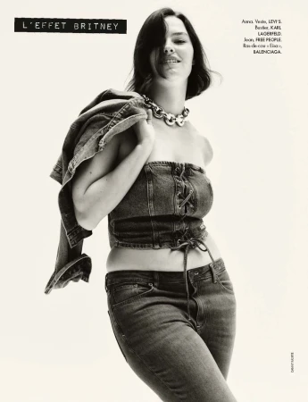 Black and white fashion editorial of model Anna Iris Dobson wearing a denim bustier and jeans for Elle France