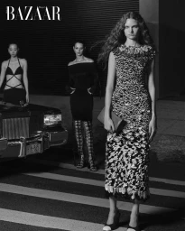 Three female models standing on a street next to a vintage car in a black and white fashion editorial for Harper's Bazaar Thailand